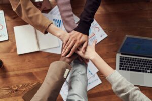 Business people put their hands together in a show of team spirit.