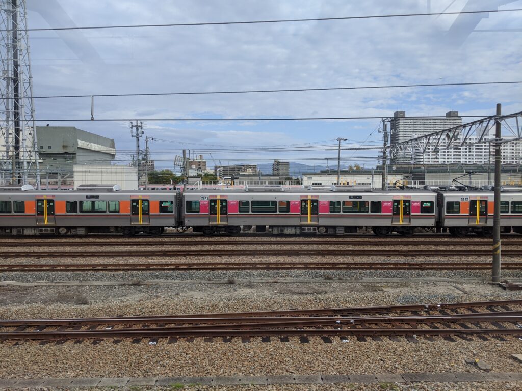 Many different train lines make up Japan's transport system. Here are the orange train carriages of the Chuo Line. 