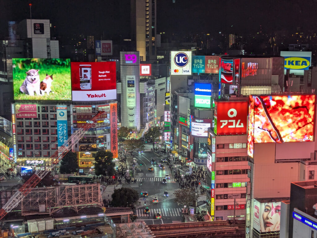 View of Shibuya at night featuring many companies.